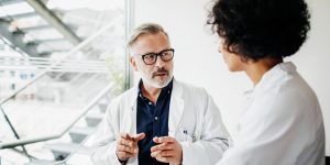 two physicians talking; one is a man and the other a woman